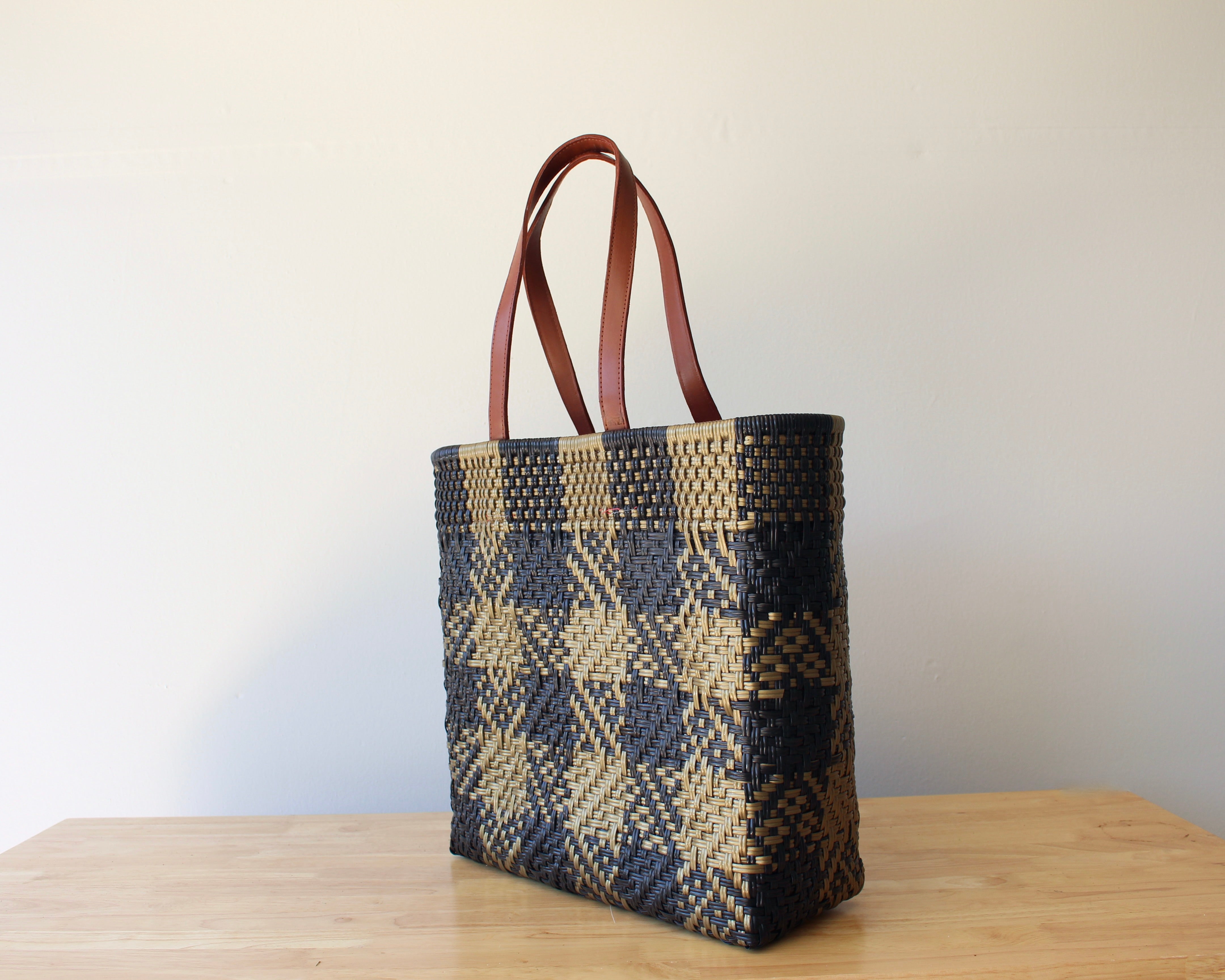 Gold and black checkered handwoven Mexican tote bag with leather handles — angled view — Alma Rosa, Domino — MexiMexi