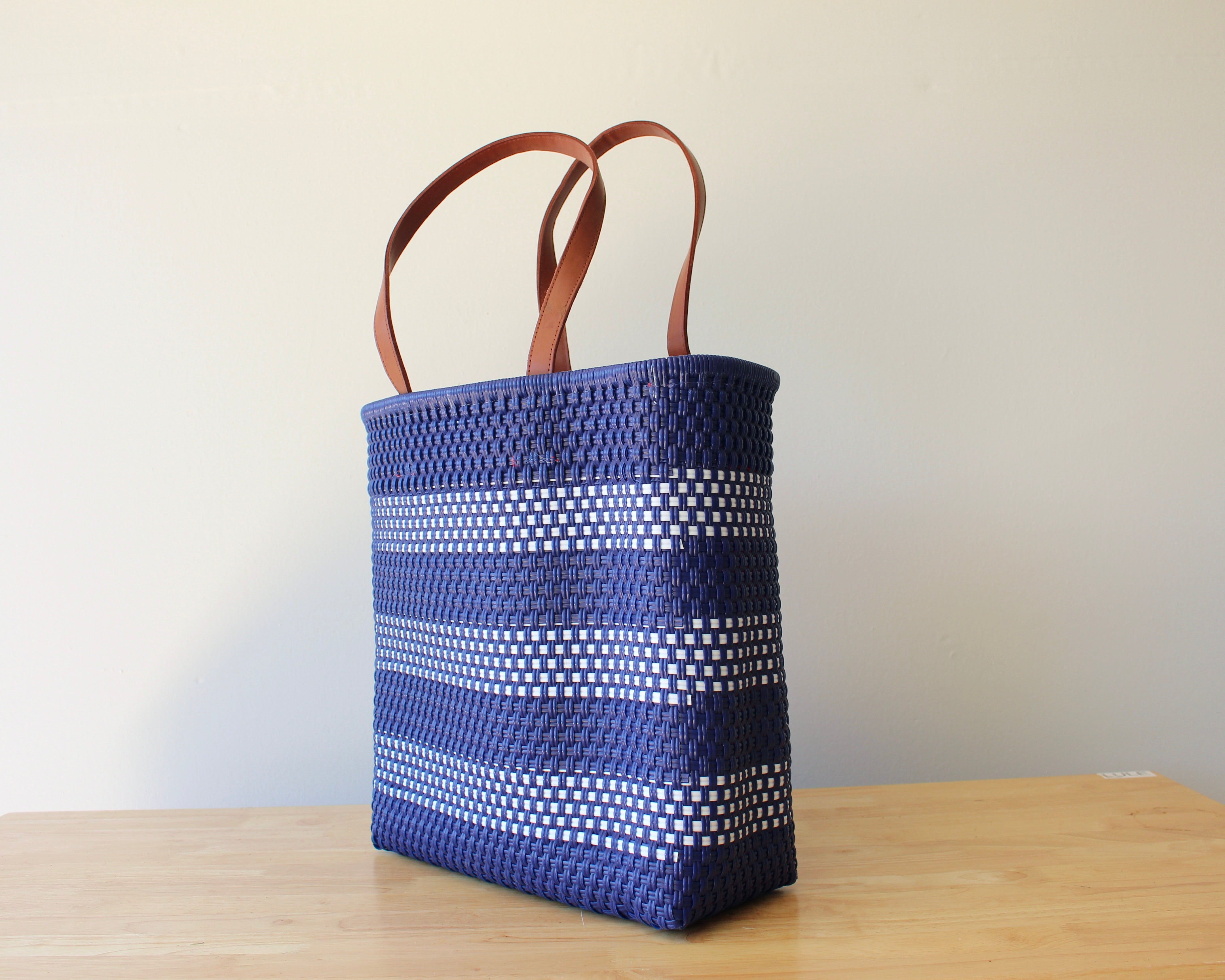 Navy blue and white handwoven Mexican tote bag with leather handles — angled view — Alma Rosa, Navy — MexiMexi