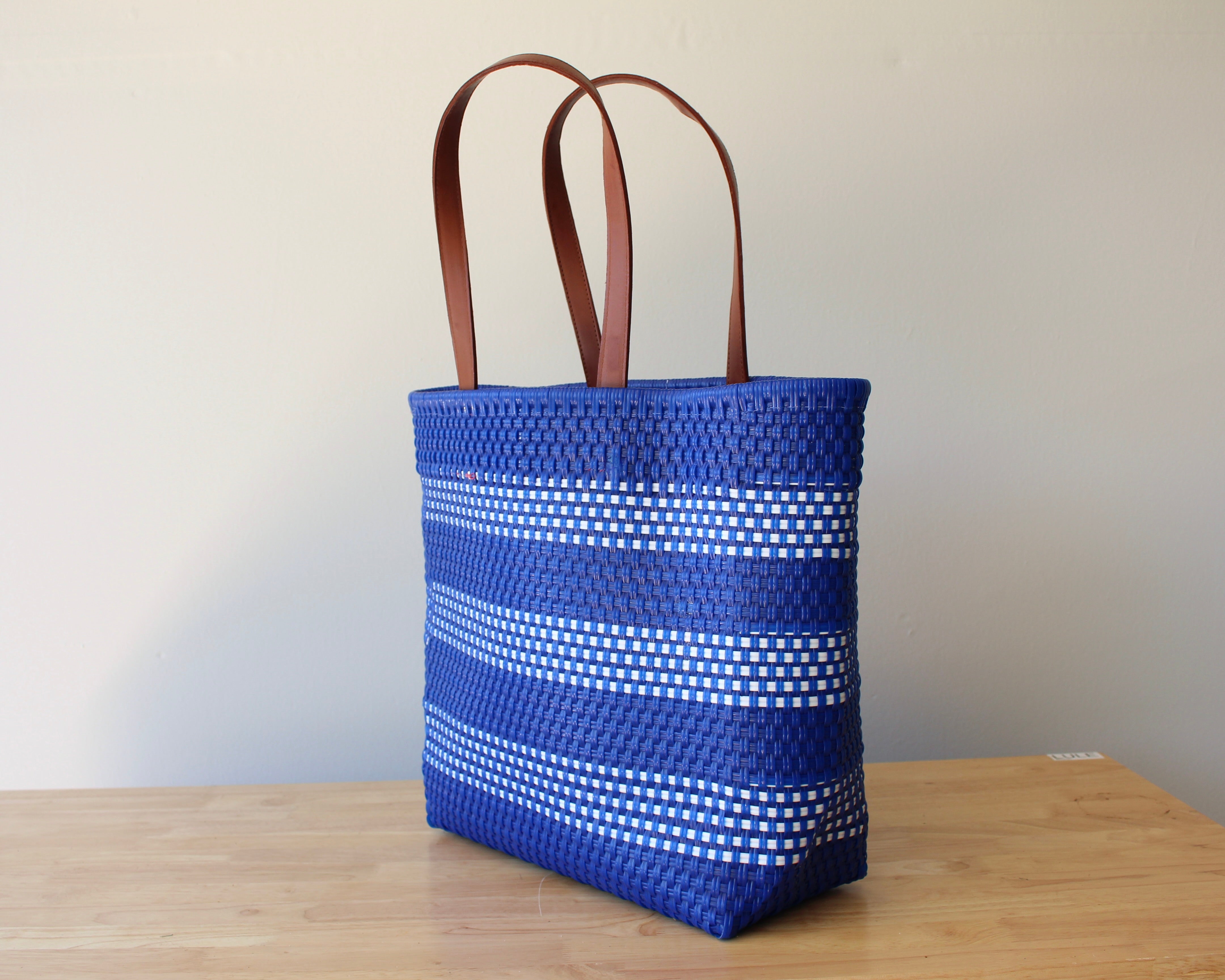 Cobalt blue and white handwoven Mexican tote bag with leather handles — angled view — Alma Rosa, Cobalt — MexiMexi
