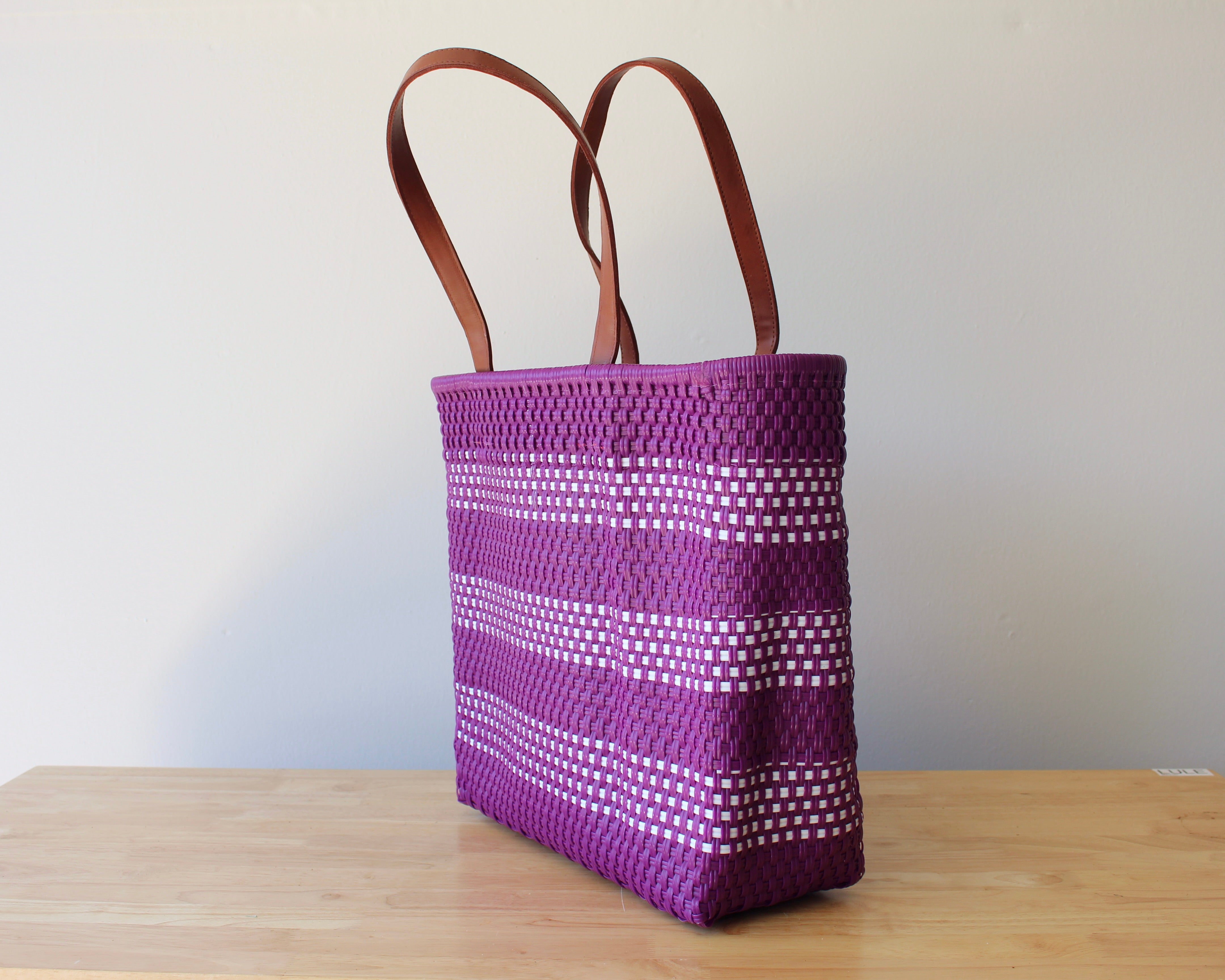 Purple and white handwoven Mexican tote bag with leather handles — angled view — Alma Rosa, Violet — MexiMexi