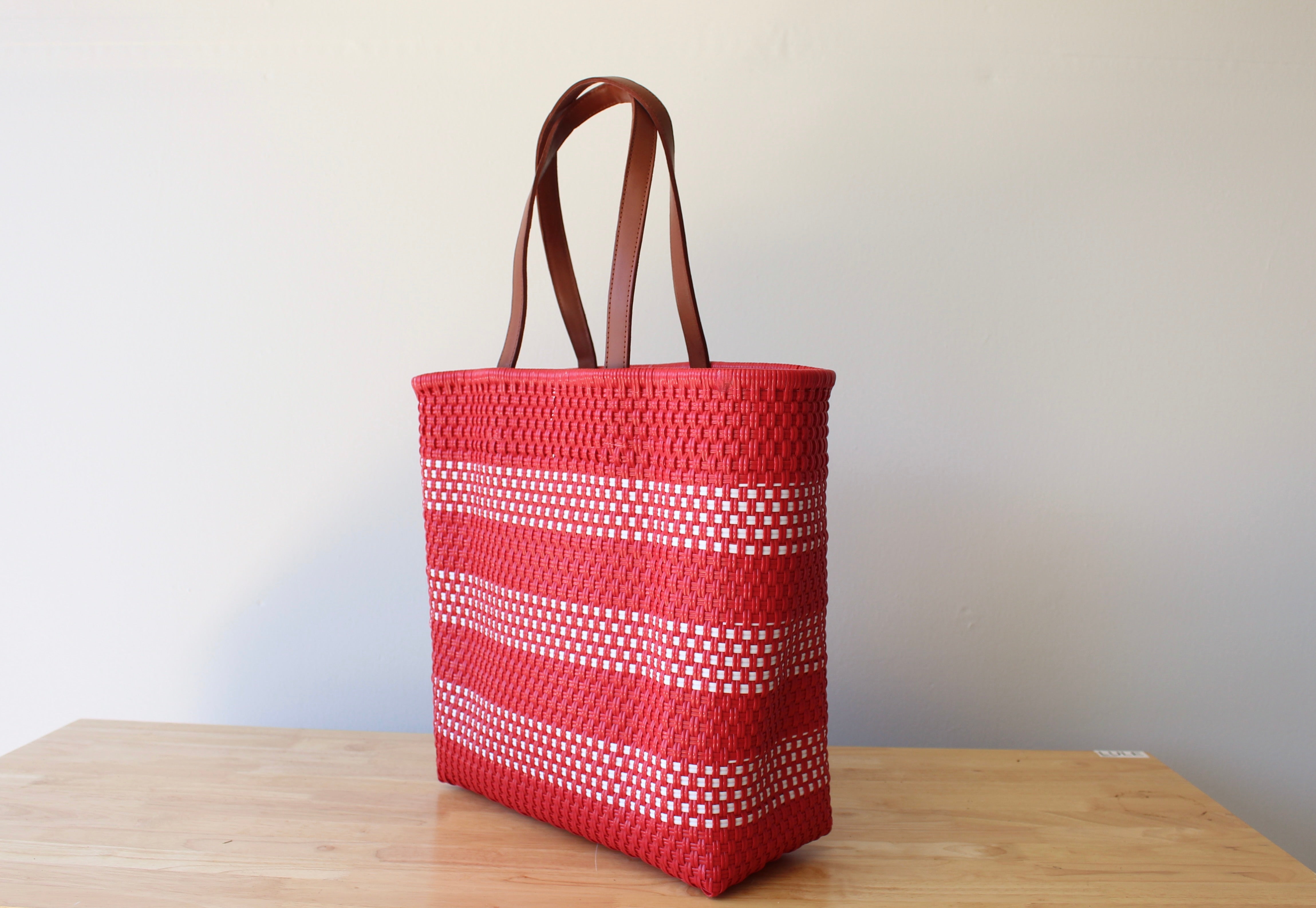 Red and white handwoven Mexican tote bag with leather handles — angled view — Alma Rosa, Scarlet — MexiMexi