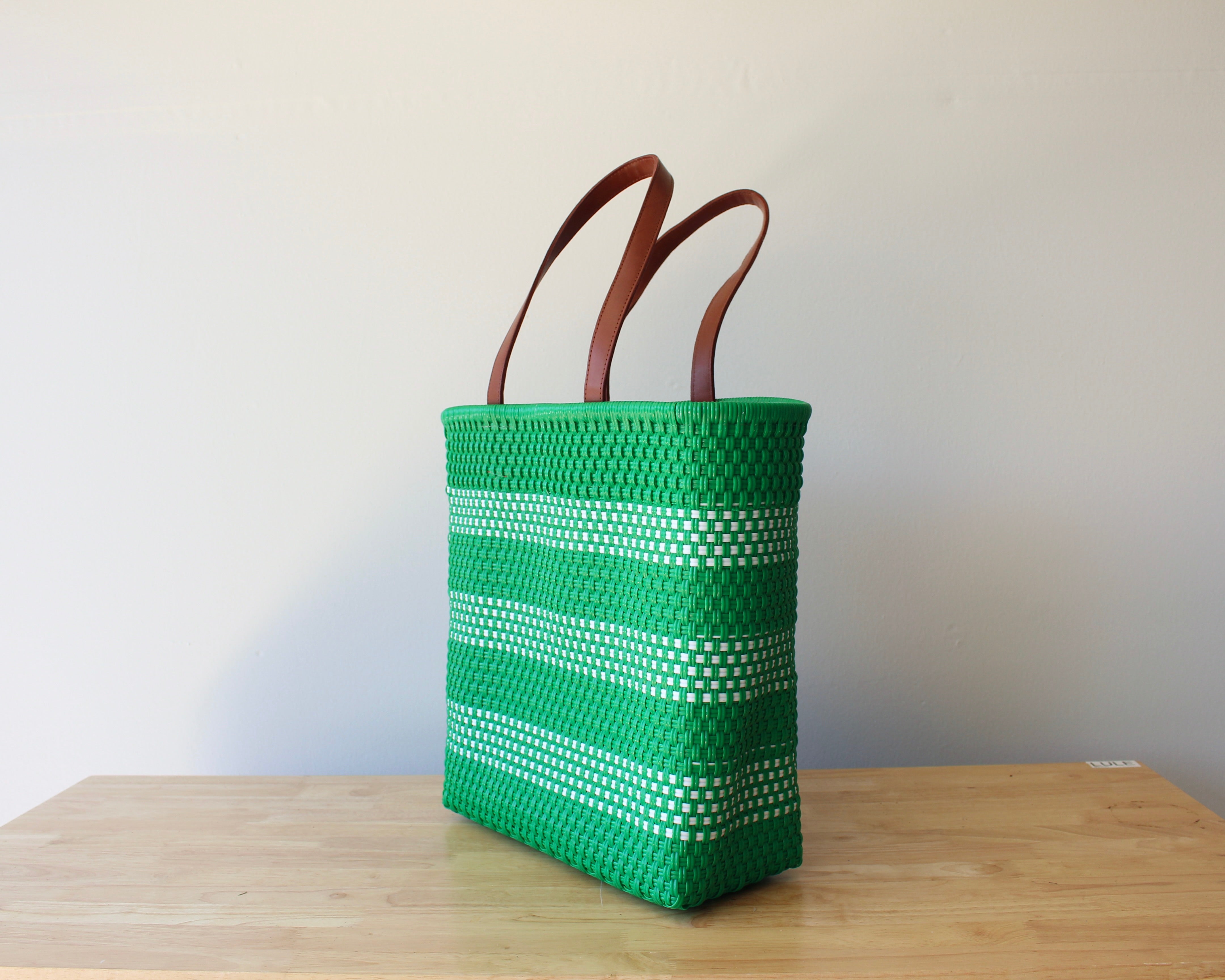 Kelly green and white handwoven Mexican tote bag with leather handles — angled view — Alma Rosa, Jade — MexiMexi