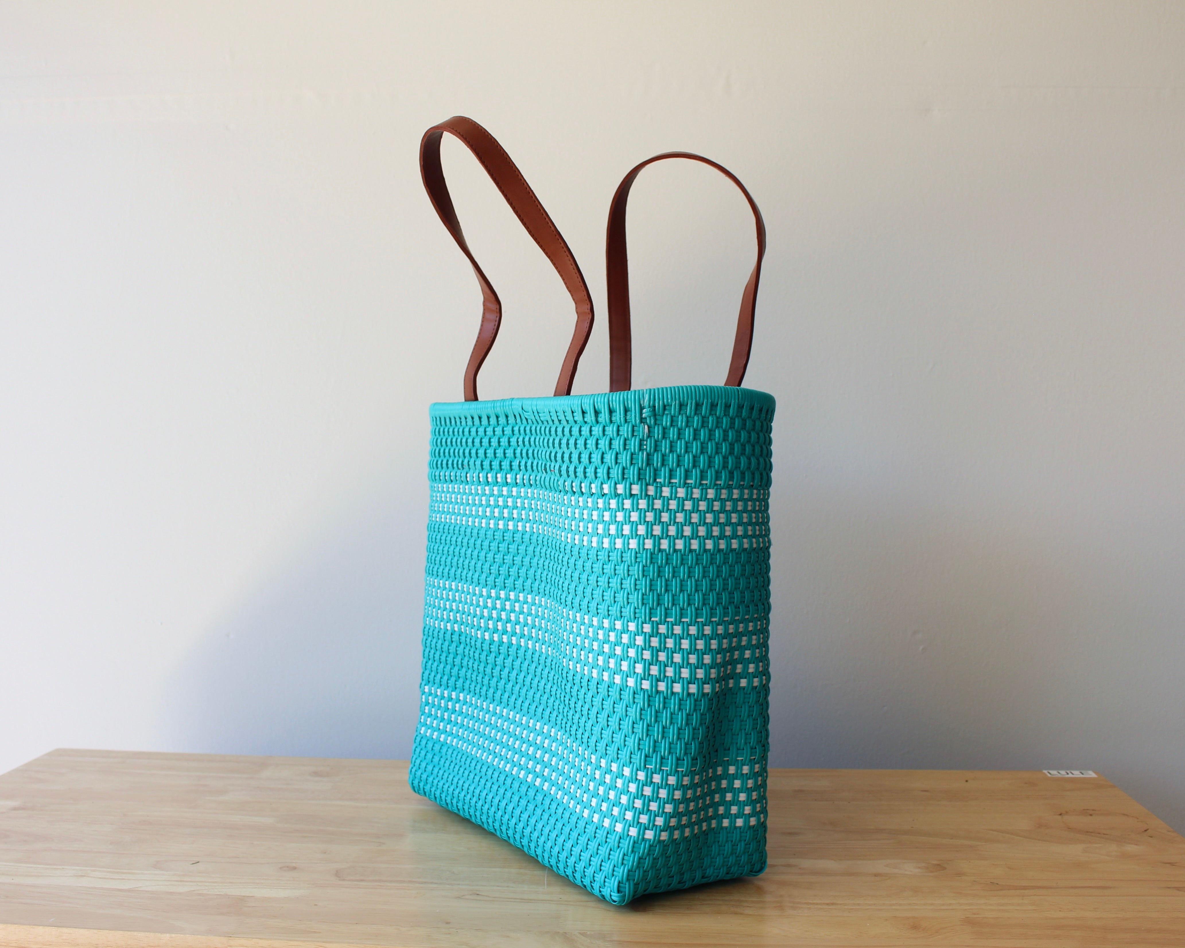 qua and white handwoven Mexican tote bag with leather handles — angled view — Alma Rosa, Aqua — MexiMexi