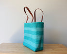 qua and white handwoven Mexican tote bag with leather handles — angled view — Alma Rosa, Aqua — MexiMexi