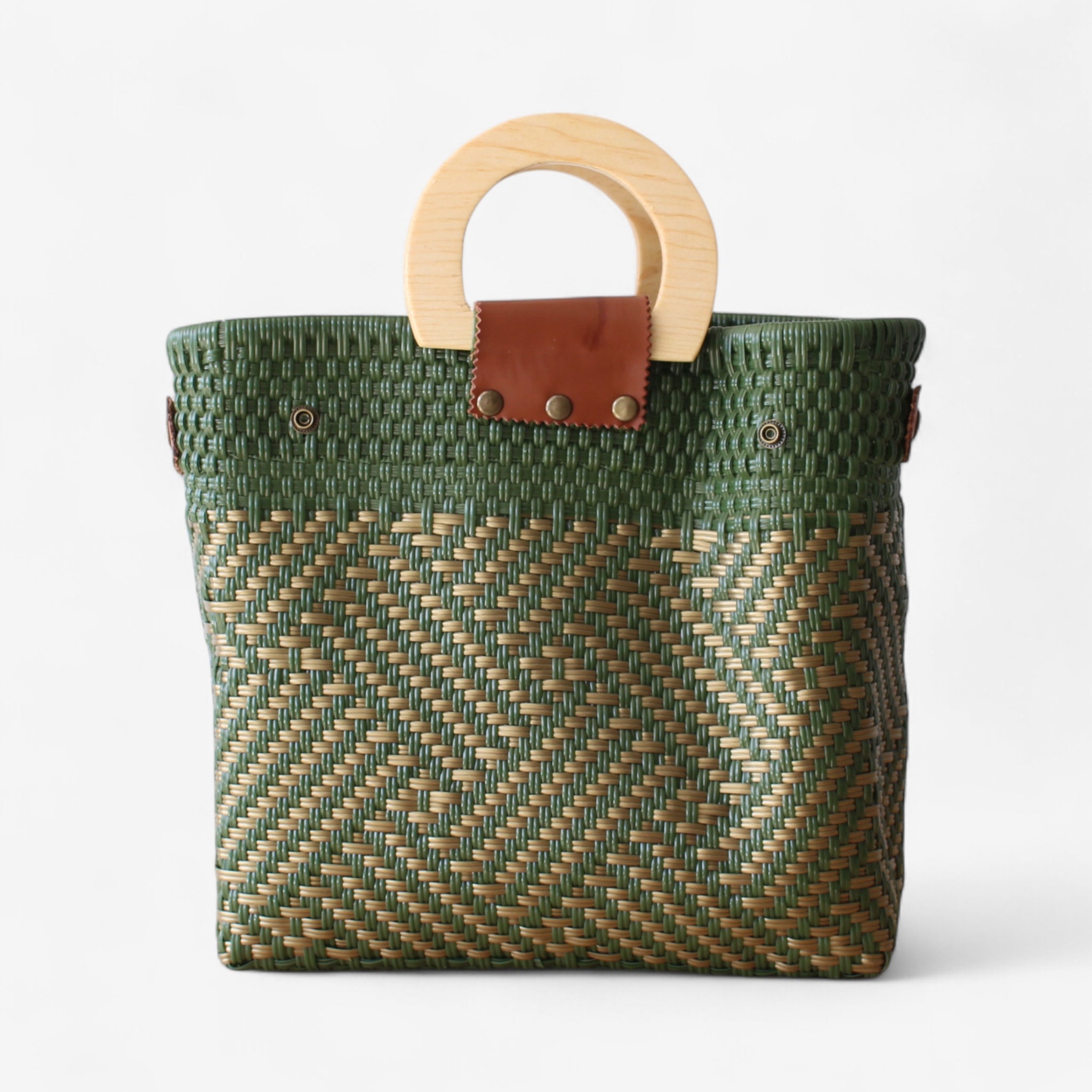 Large artisan tote bag in green with woven design and leather closure.