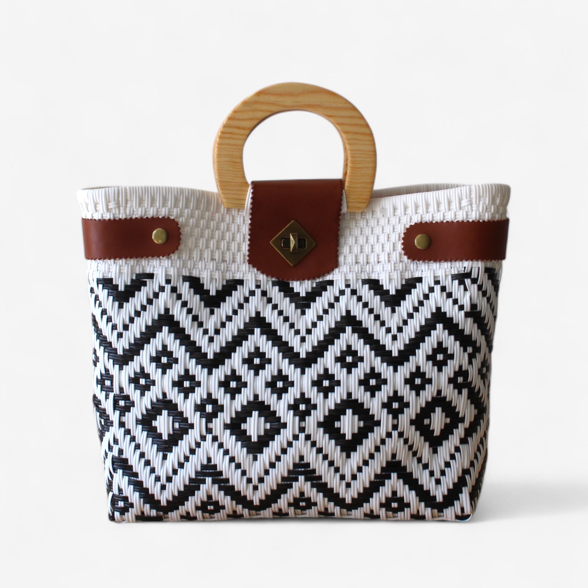 Handmade black and white geometric tote bag with wooden handles.