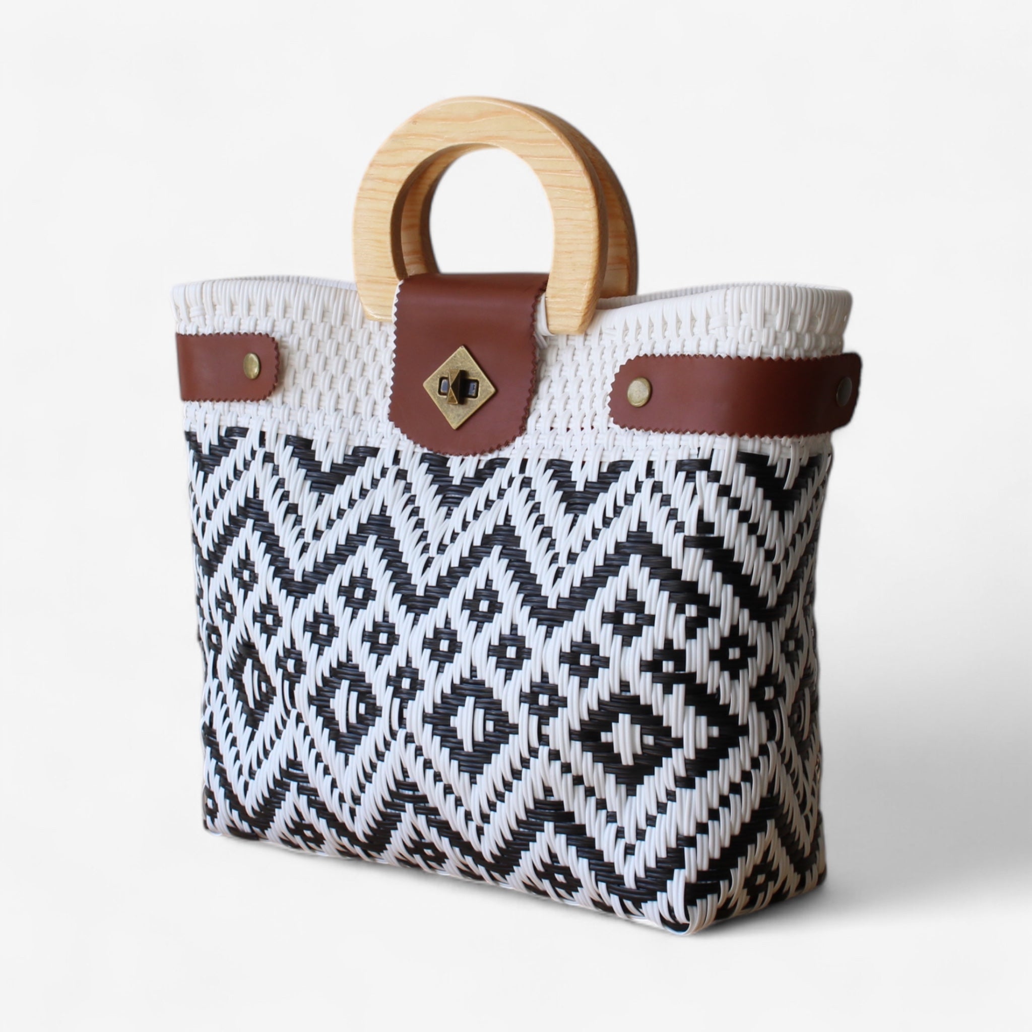 Large woven tote with leather trim and bold black and white pattern.
