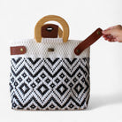 Handwoven black and white purse with geometric design and leather details